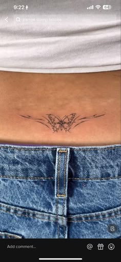 a woman's stomach with a small butterfly tattoo on her left side ribcage