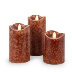 three brown candles sitting next to each other