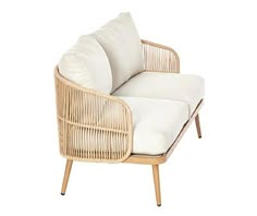 a wicker lounge chair with white cushions