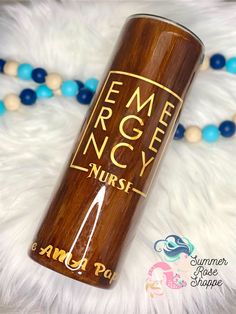 a wooden bottle sitting on top of a white fur covered floor next to blue beads