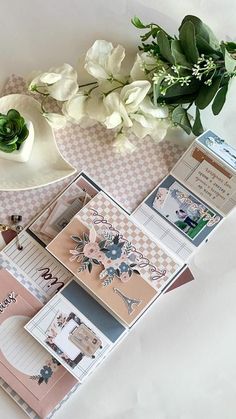 a table topped with lots of cards and flowers