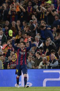 the soccer player is celebrating his team's win in front of a large crowd