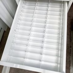 an open drawer with clear plastic drawers on it