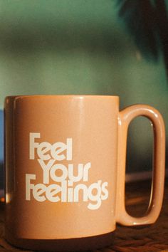 a coffee mug with the words feed your feelings on it