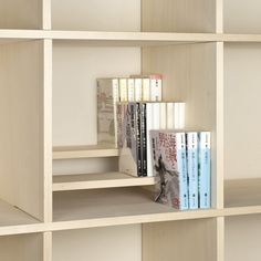 a book shelf with several books on top of it and one in the bottom row