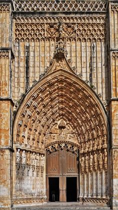 an old building with a wooden door and intricate carvings on the front entrance to it