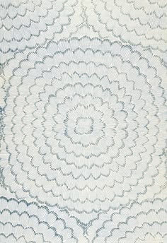 an intricate blue and white rug with wavy lines in the shape of circles on it