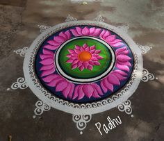 a colorful flower design painted on the ground