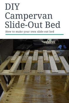 the diy campervan slide - out bed is made from wooden pallets