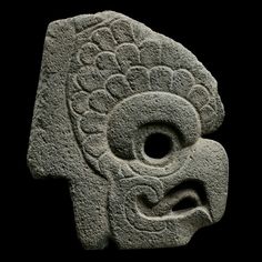 a stone sculpture with two faces on it's face and one in the shape of an elephant