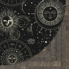 the sun, moon and stars are drawn on a black background with wood flooring