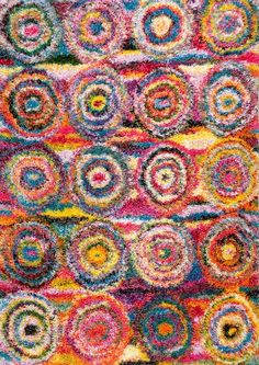 a multicolored rug with circles on it