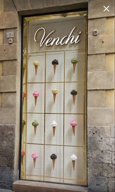 an ice cream shop front with cupcakes in the window and on the wall