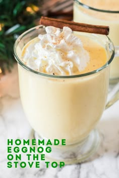 homemade eggnog on the stovetop with cinnamon and whipped cream in a mug