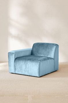 a blue chair sitting on top of a wooden floor