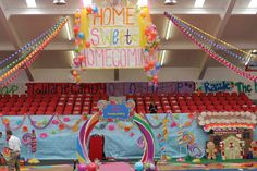 an indoor stage decorated with balloons and streamers for a home sweeter's competition