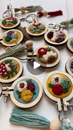 a table topped with lots of different types of buttons and tassels on top of each other