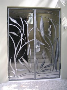 the glass doors are designed to look like they have leaves and flowers on them,