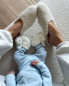 a person laying on the floor with two stuffed animals