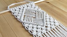 a white crocheted doily sitting on top of a wooden floor