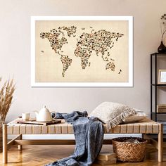 the world map is made up of cats and birds on parchment colored paper, framed in white frame