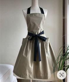 the apron dress is being displayed on a mannequin