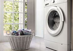 a laundry basket sitting next to a washing machine