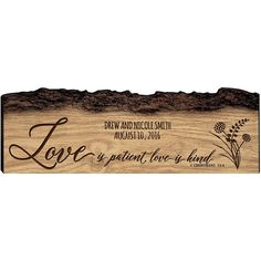 a wooden sign that says love is patient love is kind with flowers and leaves on it