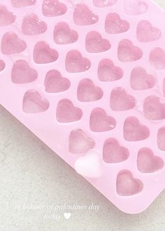 a pink heart shaped ice tray sitting on top of a counter