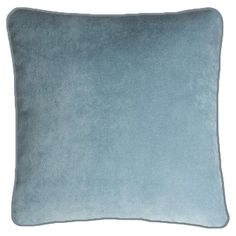 a blue velvet pillow on a white background