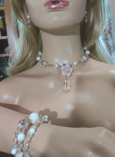 Romantic Porcelain Rose & Chandelier Crystal Necklace Set w/Matching Bracelet and Earrings. German Glass Flower Beads. Pink and Aurora Borealis Clear Czech Crystals. Gold Plated Accent Beads, Clasp, and Chain. Chandelier Crystal and Porcelain Rose Pendant. This Choker-Style Necklace is 16" Long w/ a 5 1/2" Extender Chain, so it can accommodate any Neckline. The Pendant Drop Length is 1 1/4". The Memory Wire Bracelet and Earrings also have Czech Crystals and German Flower Beads. The Earrings have a 1 1/4" Drop Length, and Gold-Plated Leverbacks. For Pierced Ears and Hypoallergenic. The Bracelet will include a Safety Chain that you can remove if you wish. Hand-Made. One of a Kind (OOAK). SLG Jewelry Designs. SLG Original. Elegant Pink Rose Quartz Crystal Necklace, Elegant Nickel-free Pink Chandelier Earrings, Pink Rose Quartz Jewelry With Matching Earrings, German Flower, Glamorous Pink Crystal-embellished Jewelry, Pink Bohemian Nickel-free Chandelier Earrings, Choker Style Necklace, Porcelain Roses, Rose Pendant