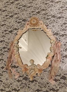 an ornate mirror on a lace table cloth