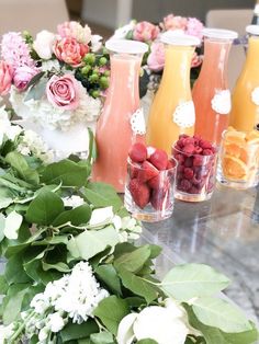 several vases filled with fruit and flowers on a table