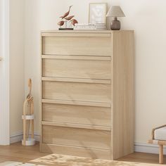 a wooden dresser sitting next to a white wall in a room with hardwood flooring