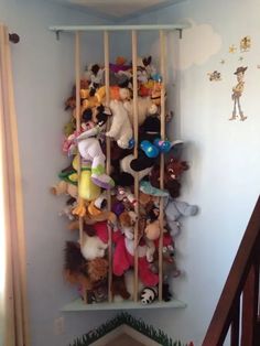 a bunch of stuffed animals are on the wall in this child's playroom