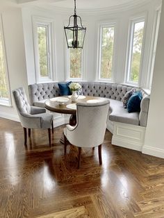 a living room with two couches and a table in the middle of the room