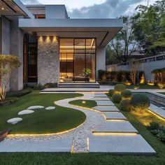 a modern house that is lit up at night