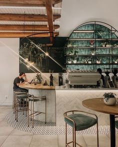 a man sitting at a counter in a coffee shop