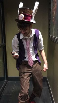 a man dressed up as a rabbit in a top hat and tie holding a cell phone