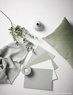 a white table topped with green and gray items