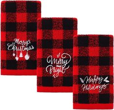 three red and black flannel towels with merry holidays written on them