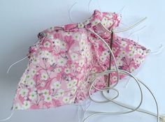 a pair of pink and white flowered cloths with wires attached to them