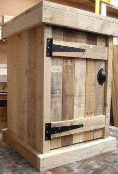 a wooden box sitting on top of a table next to some wood planks and metal hardware