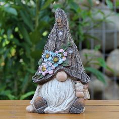 a gnome figurine sitting on top of a wooden table