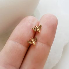 "⚡️ FREE SHIPPING ⚡️ on Domestic orders over $35 🇺🇸 🐝 These tiny bee stud earrings are made of Sterling silver, (and Gold vermeil) or Bronze, so they're waterproof - perfect for the beach and poolside. * T H E * D E T A I L S *  * All components are Sterling silver, Bronze with Sterling silver posts or Gold Vermeil * Model is wearing the Bronze Bees * Bees measure (in inches) Length: 0.37  Width: 0.43  Height: 0.08 * Thoughtfully packaged & ready for gift-giving! * Handmade, just for you, in Nils Style, Bee Jewellery, Bee Studs, White Jewelry Box, Bee Jewelry, Sunny California, Gold Bee, Bee Earrings, Studio Blue