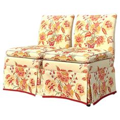 an upholstered couch with red and yellow flowers on it's back end