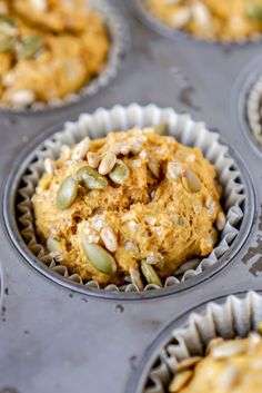 several muffins with pumpkin seeds and nuts in them