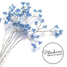 a bunch of blue flowers sitting on top of a white table