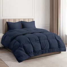 a blue comforter on a bed in a room