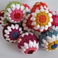 several crocheted balls are sitting on a table